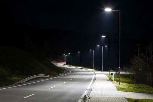 A street at night, illuminated by LED streetlights.