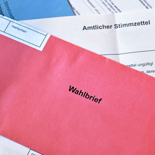 Red German postal voting envelope with German text saying 'voting letter'