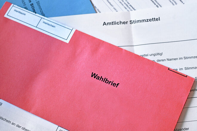 Red German postal voting envelope with German text saying 'voting letter'