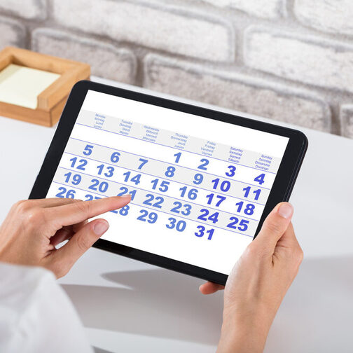 Businessperson Holding Digital Tablet With Calendar On Screen