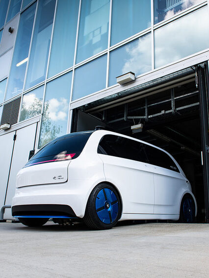 White city car that is being developed by the German Aerospace Center. It is called the Urban Modular Vehicle.